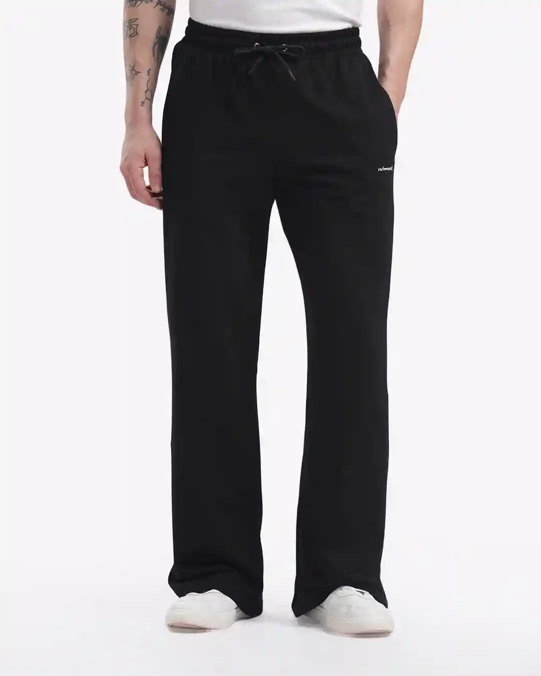 Person wearing black pants on a white background