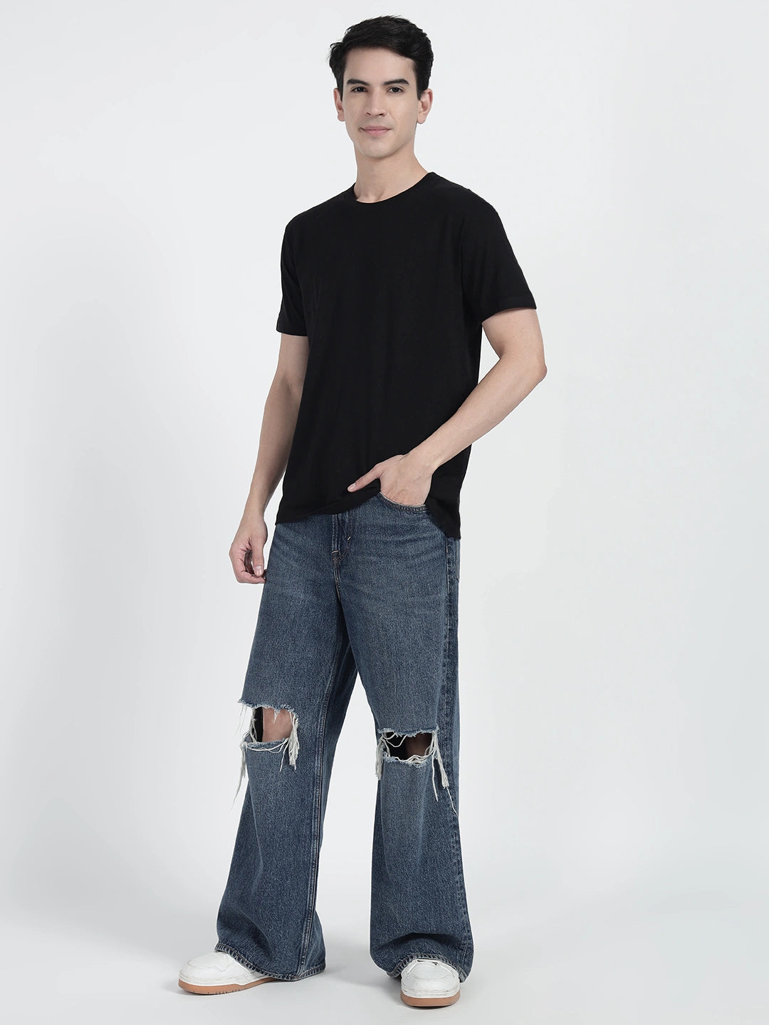 A person standing and holding a basketball, wearing a black plain T-shirt by cartonpanti india