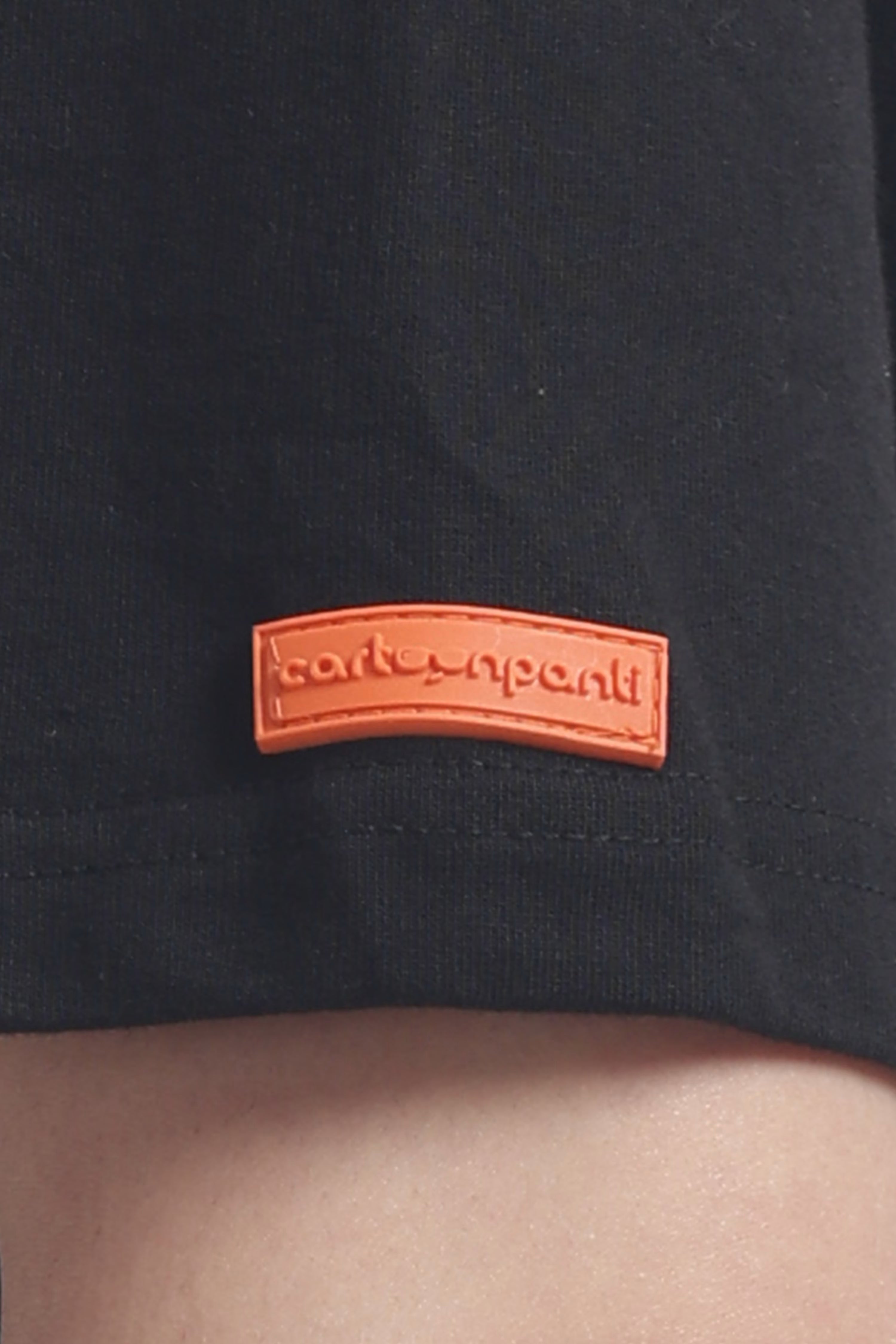 Black t-shirt with an orange logo on a plain background