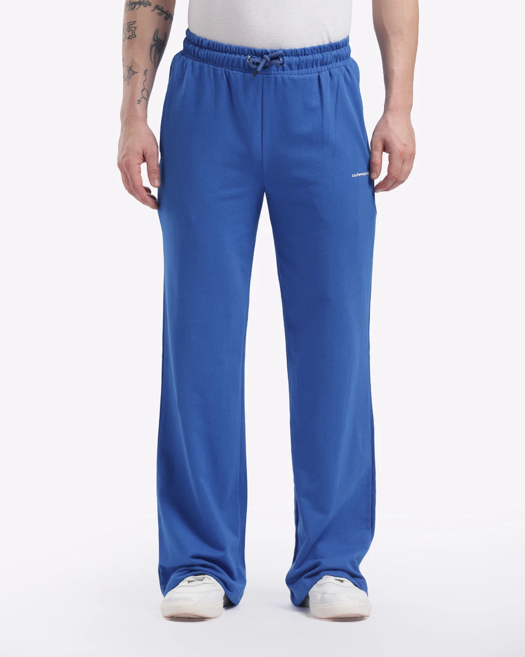 Person wearing blue sweatpants with a visible brand logo on a white background