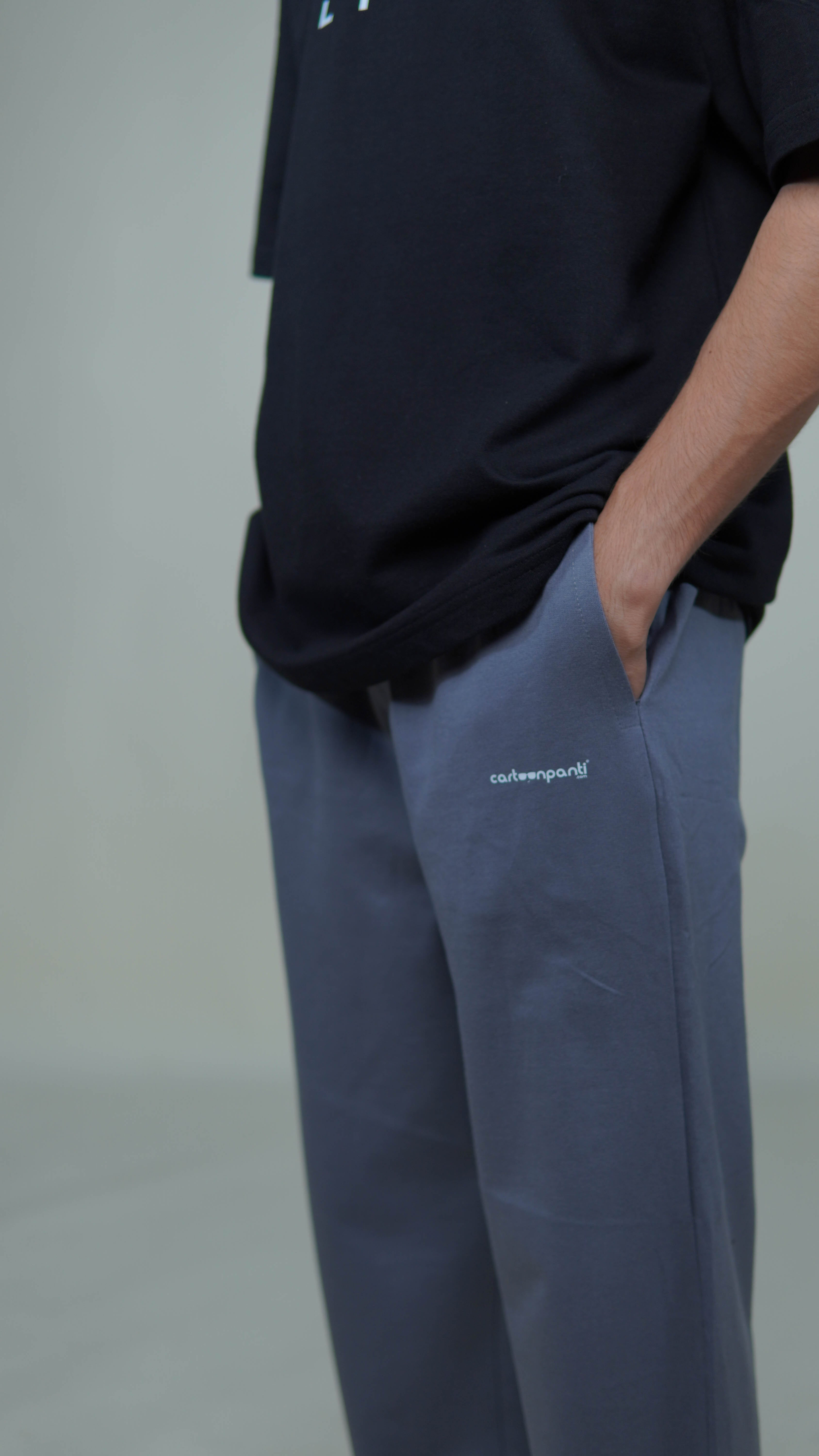 grey joggers with a visible brand logo cartoonpanti on a neutral background