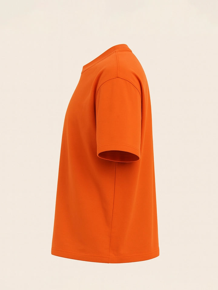Orange t-shirt on a beige background