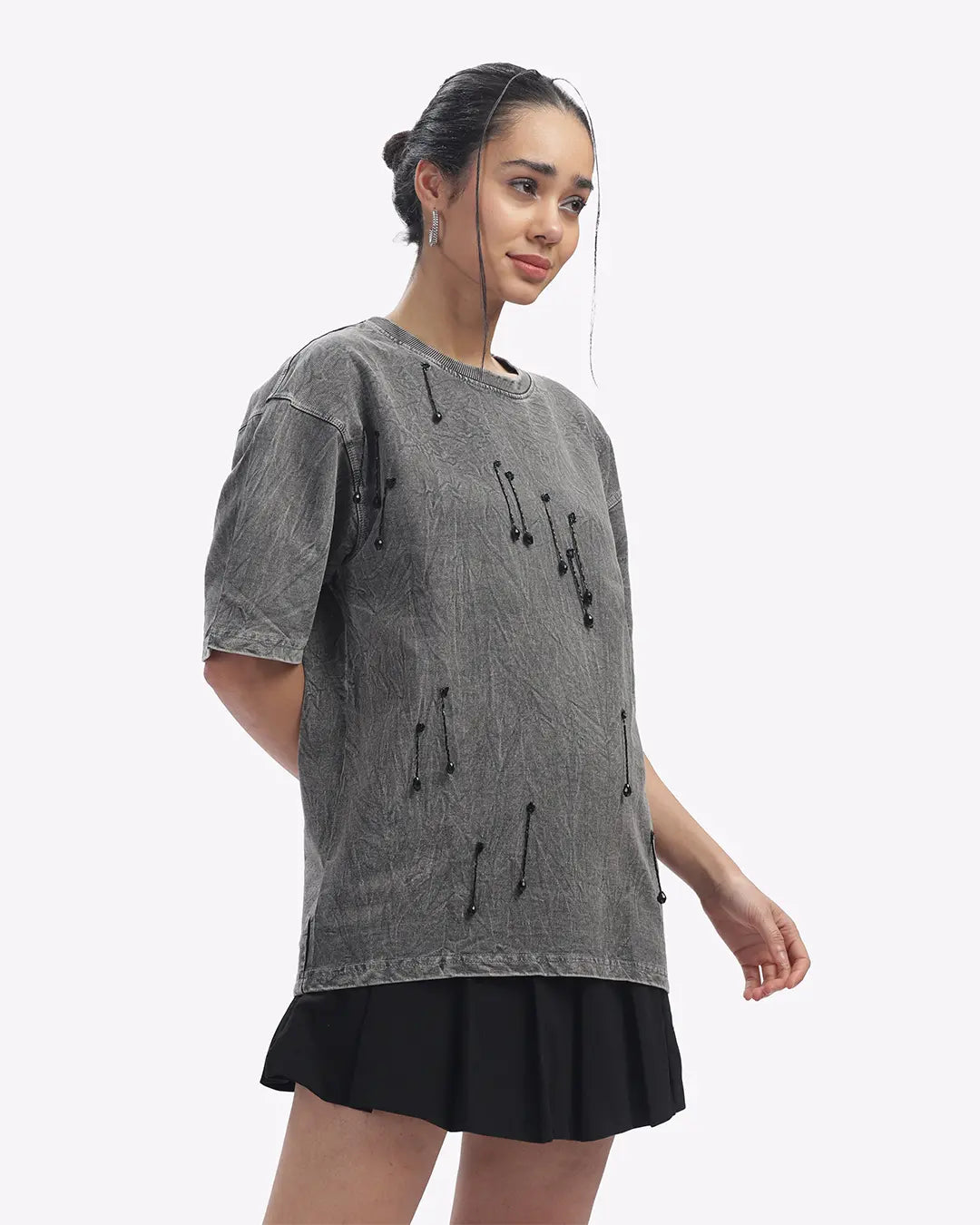 Woman wearing a gray t-shirt with black drawstrings on a white background
