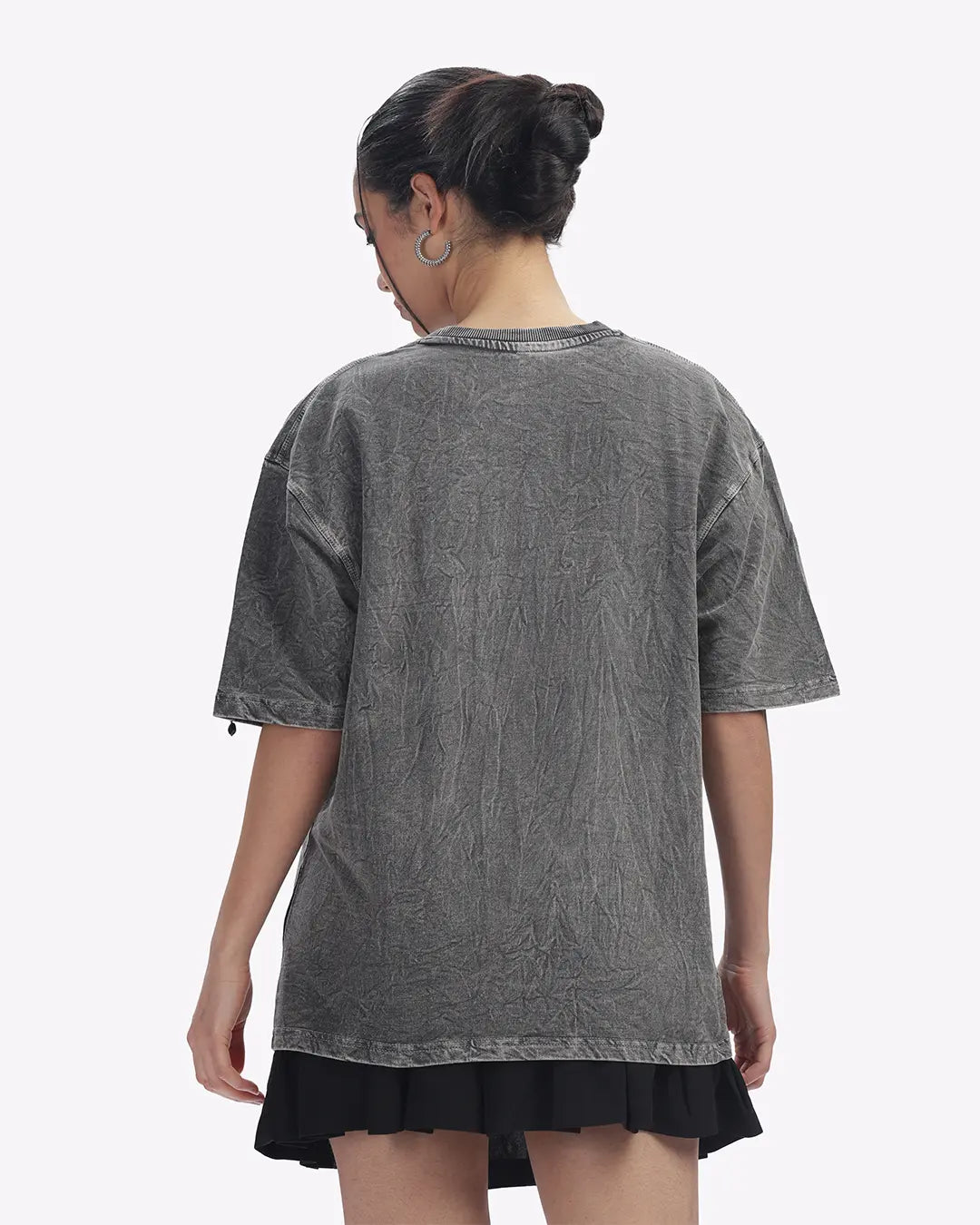 Person wearing a gray t-shirt with a white background