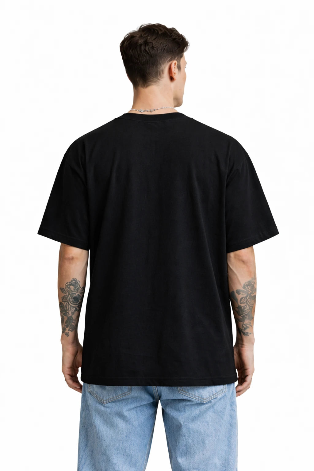 Person wearing a black t-shirt and light blue jeans on a white background