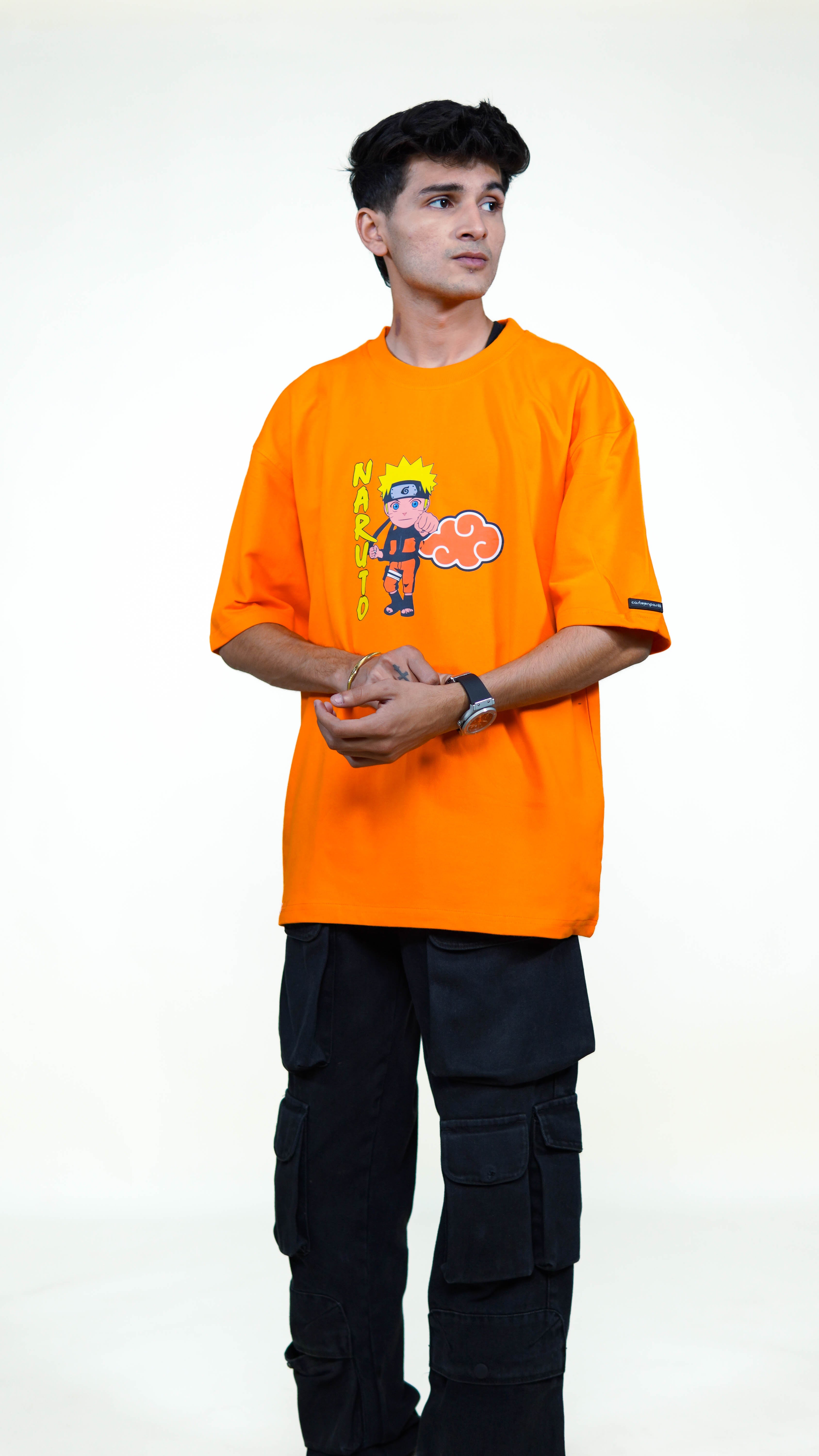 Person wearing an orange t-shirt with a cartoon naruto character