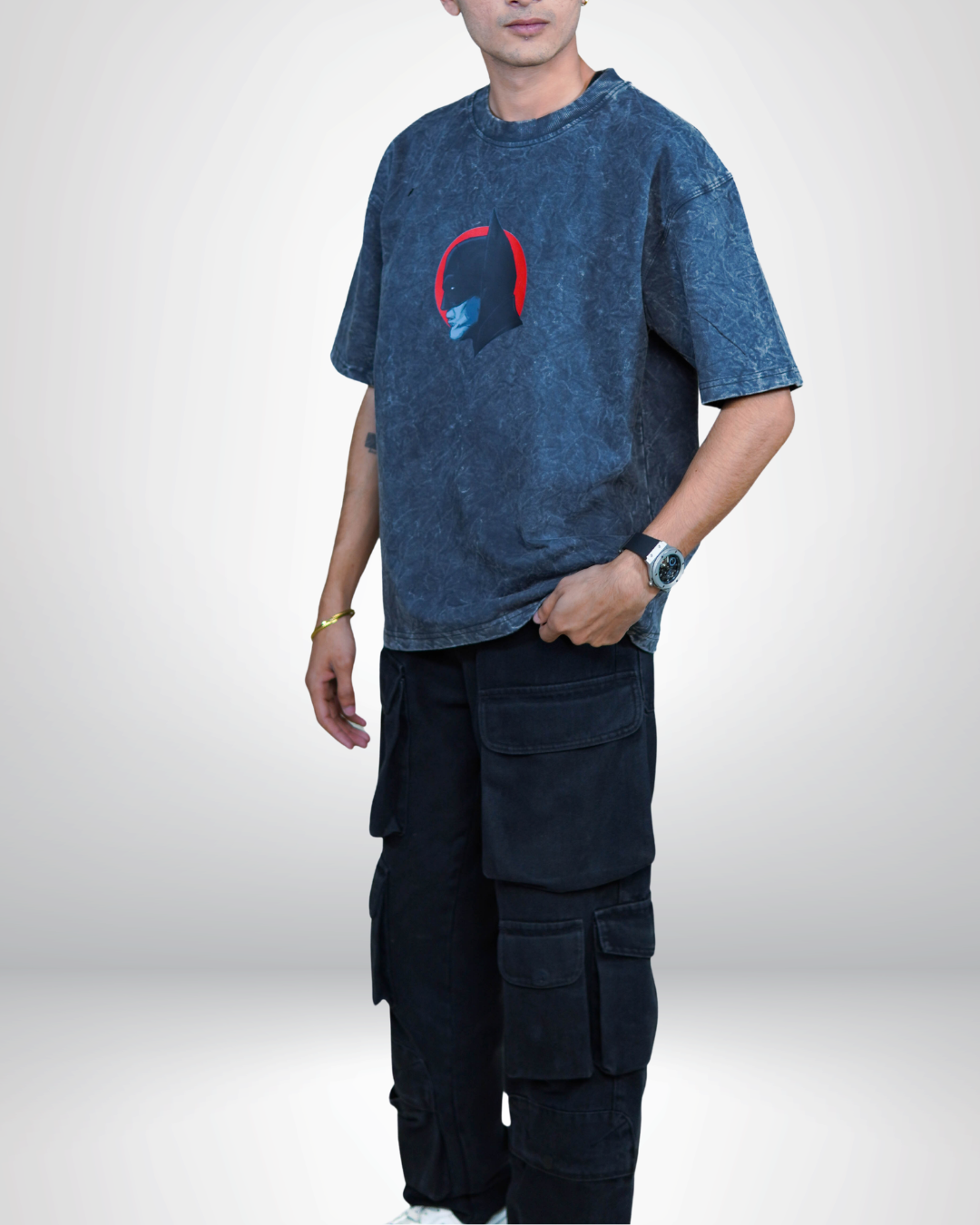 Person wearing a acid grey bat man graphic t-shirt with a prominent design on the back.