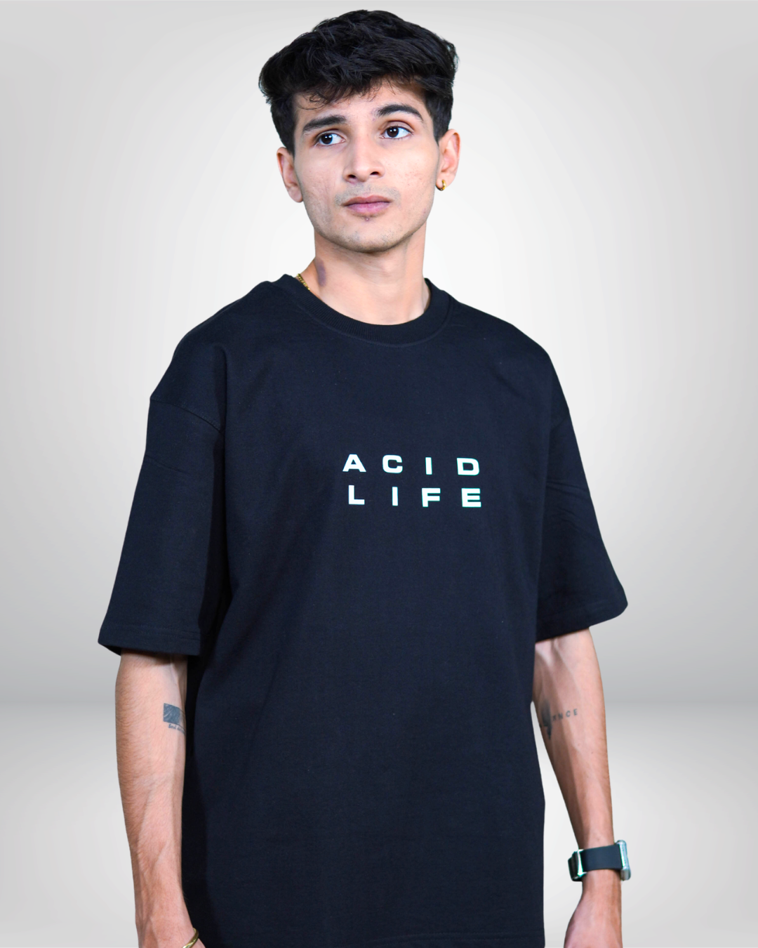 Person wearing a black t-shirt with 'ACID LIFE' text on a plain background