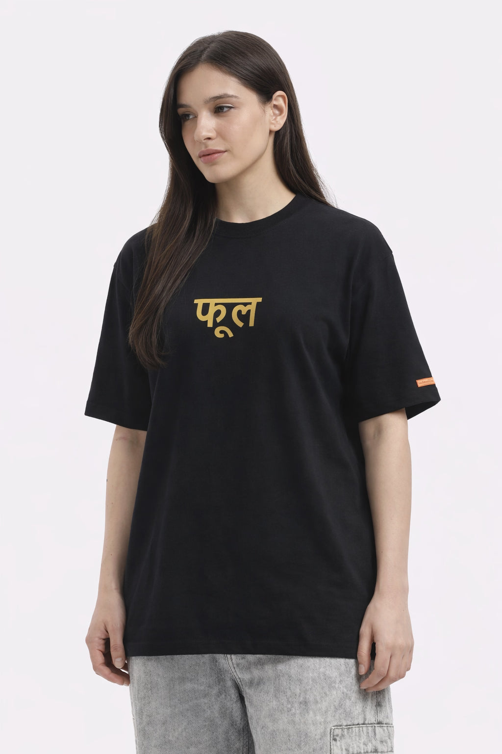 Person wearing a black t-shirt with colorful floral design on the back against a white background