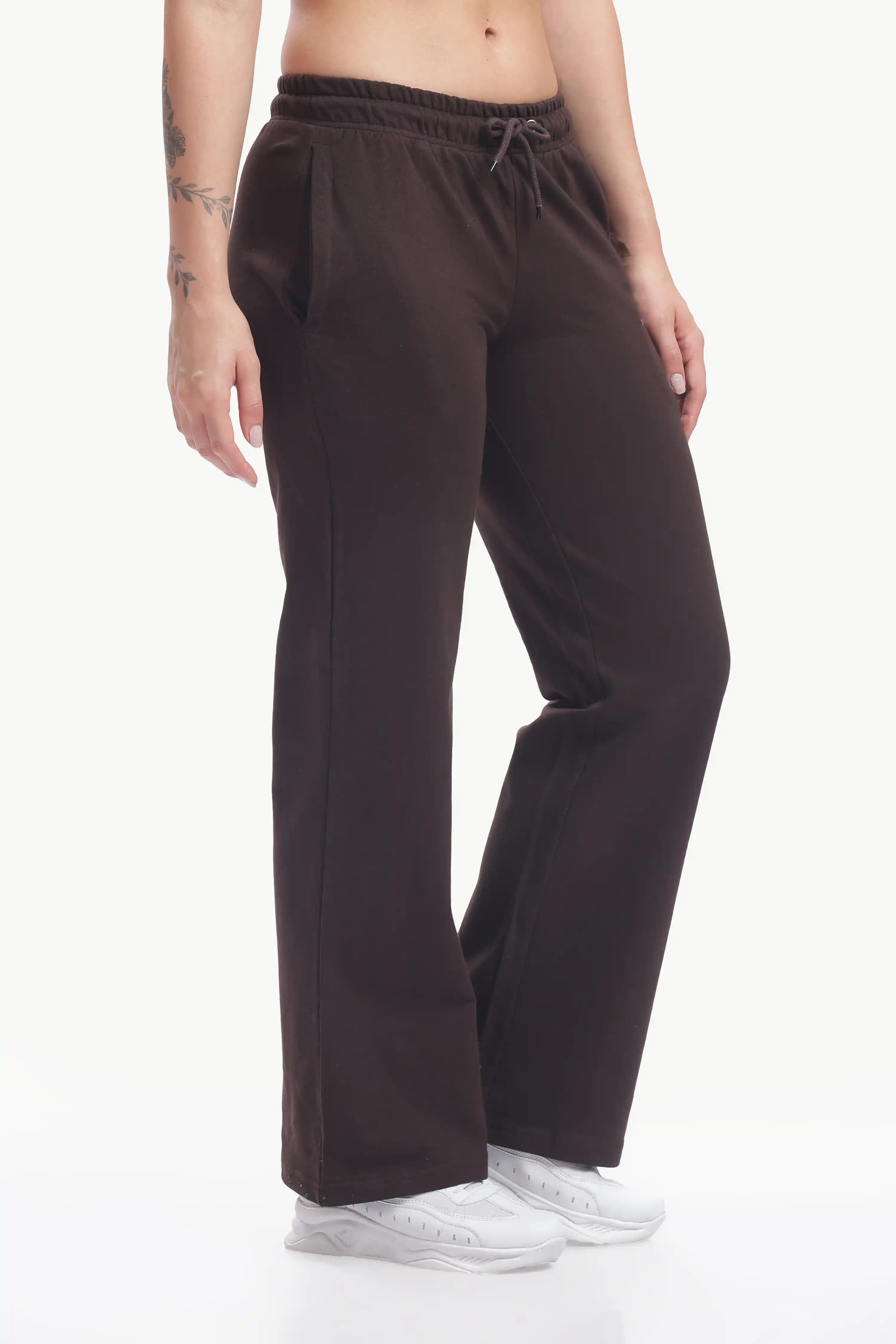 Brown sweatpants worn by a person on a white background