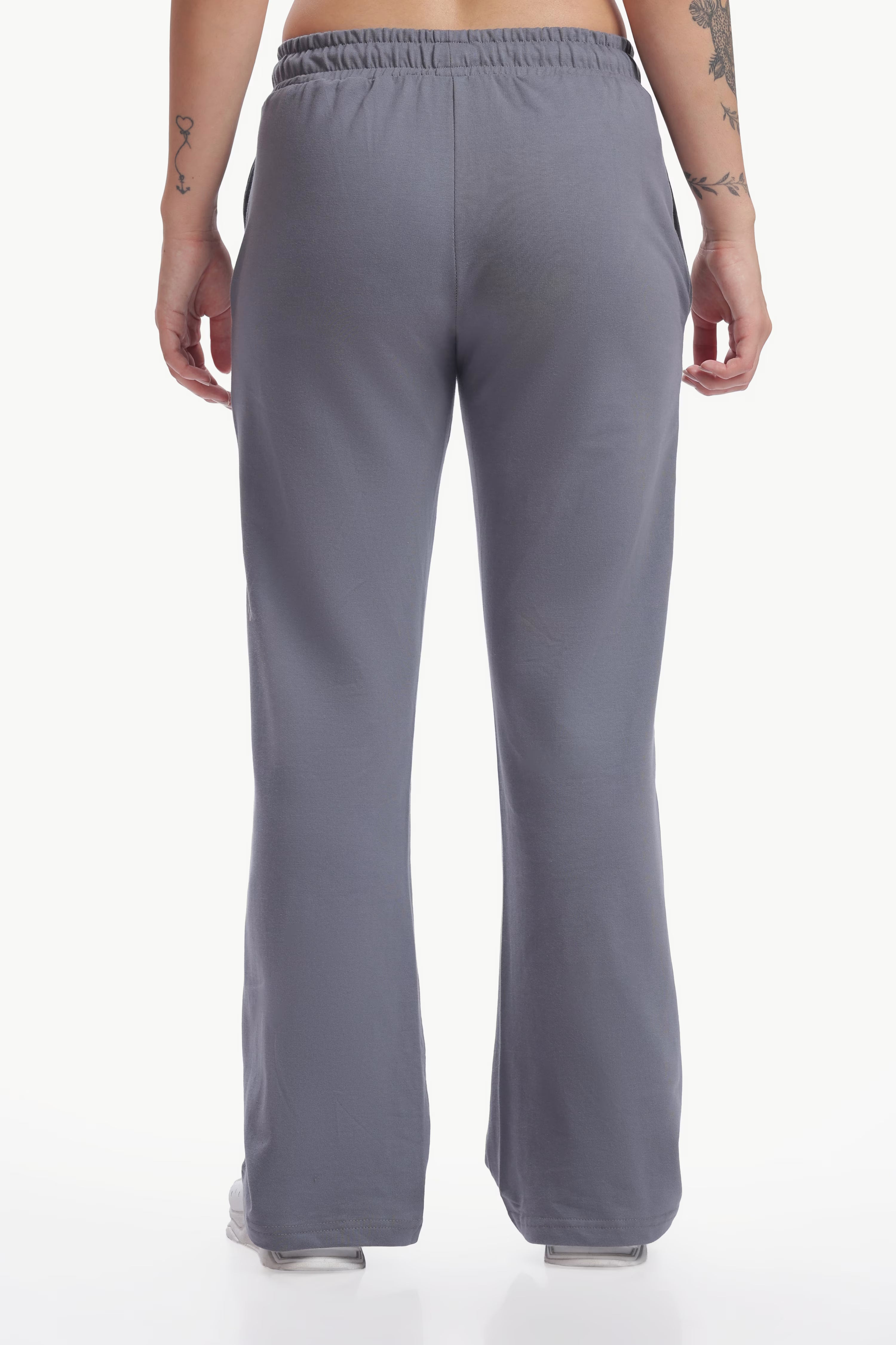 Gray pants worn by a person on a white background