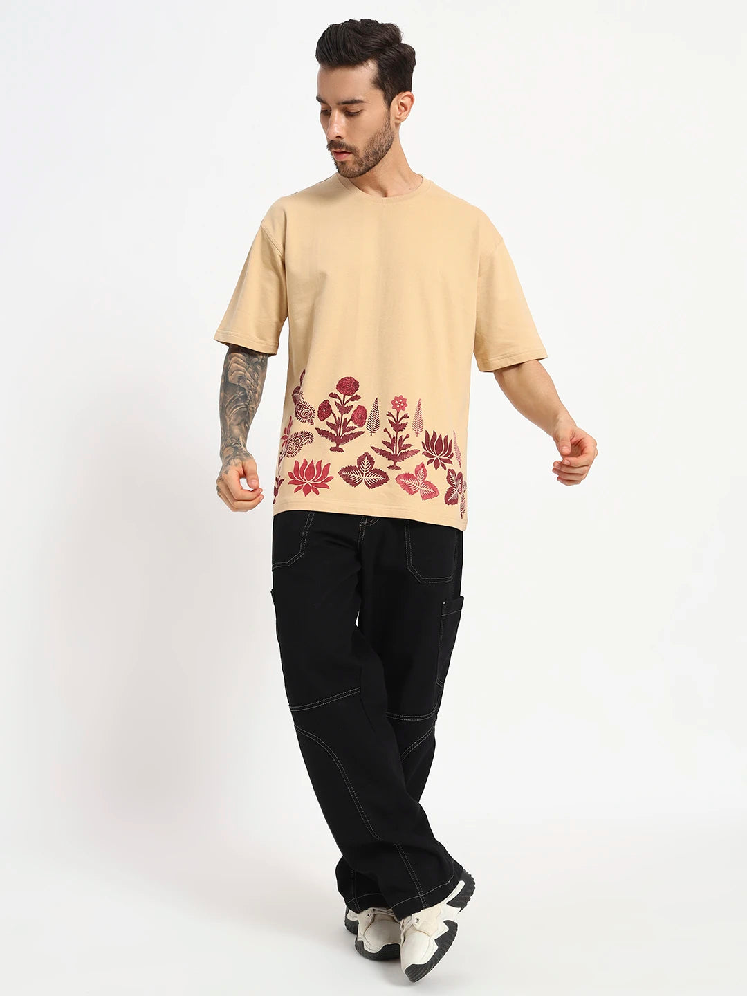 Man wearing a oversized beige t-shirt with floral patterns by cartoonpanti india