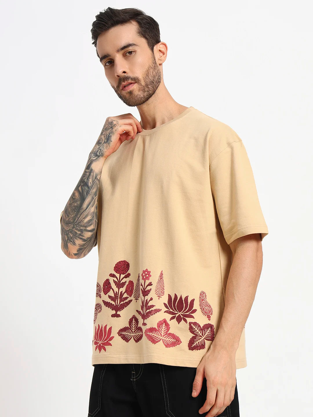 Man wearing a beige t-shirt with red floral patterns  by cartoonpanti by india