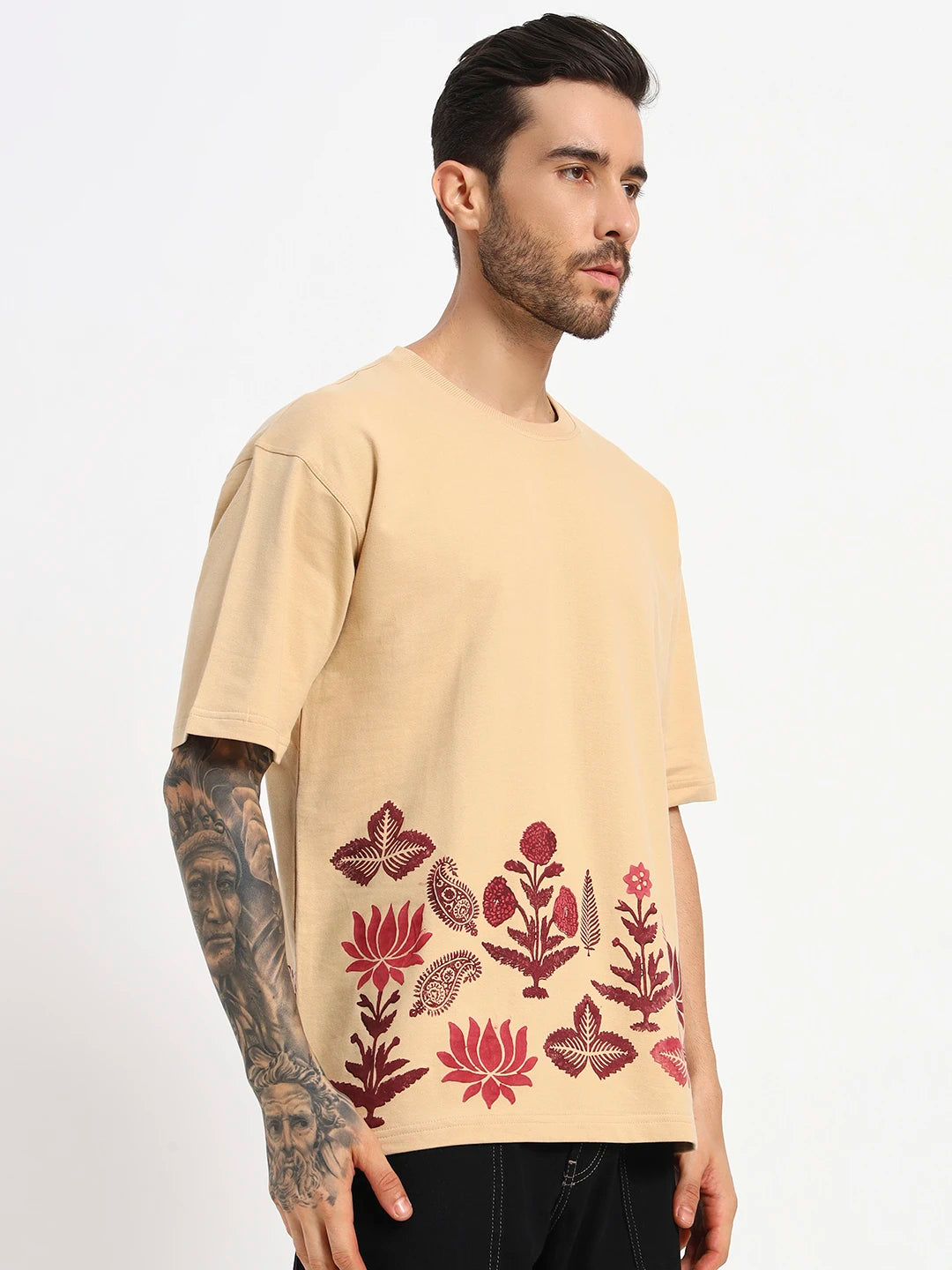 Man wearing a beige t-shirt with red floral patterns  by cartoonpanti by india