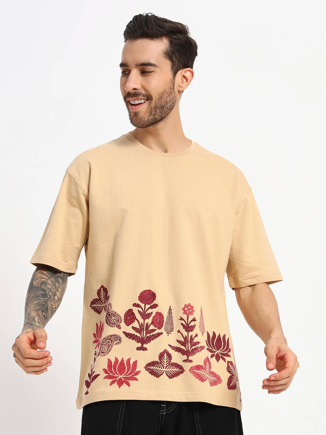 Man wearing a beige t-shirt with red floral patterns by cartoonpanti by india