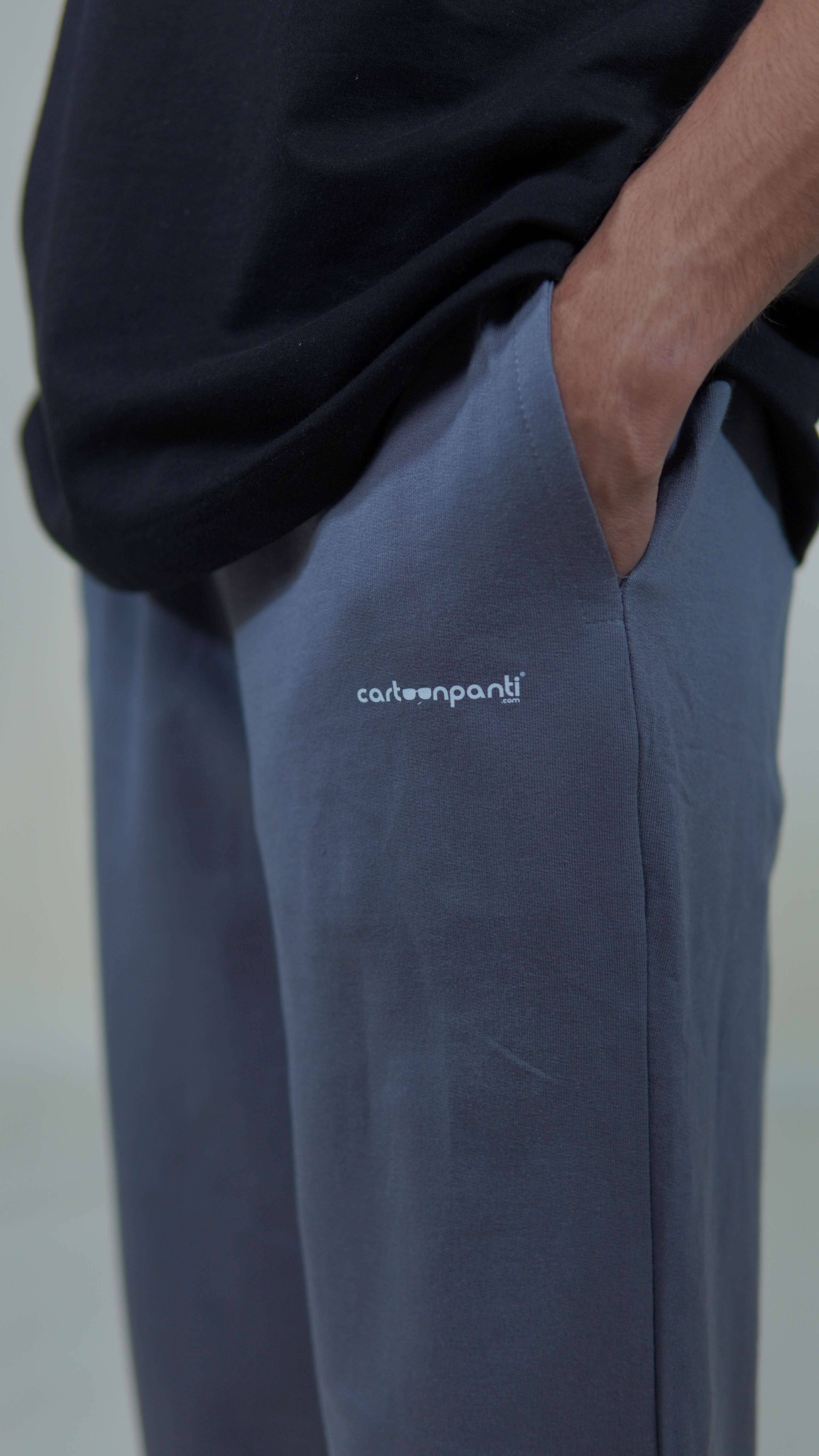 grey joggers with a visible brand logo cartoonpanti on a neutral background