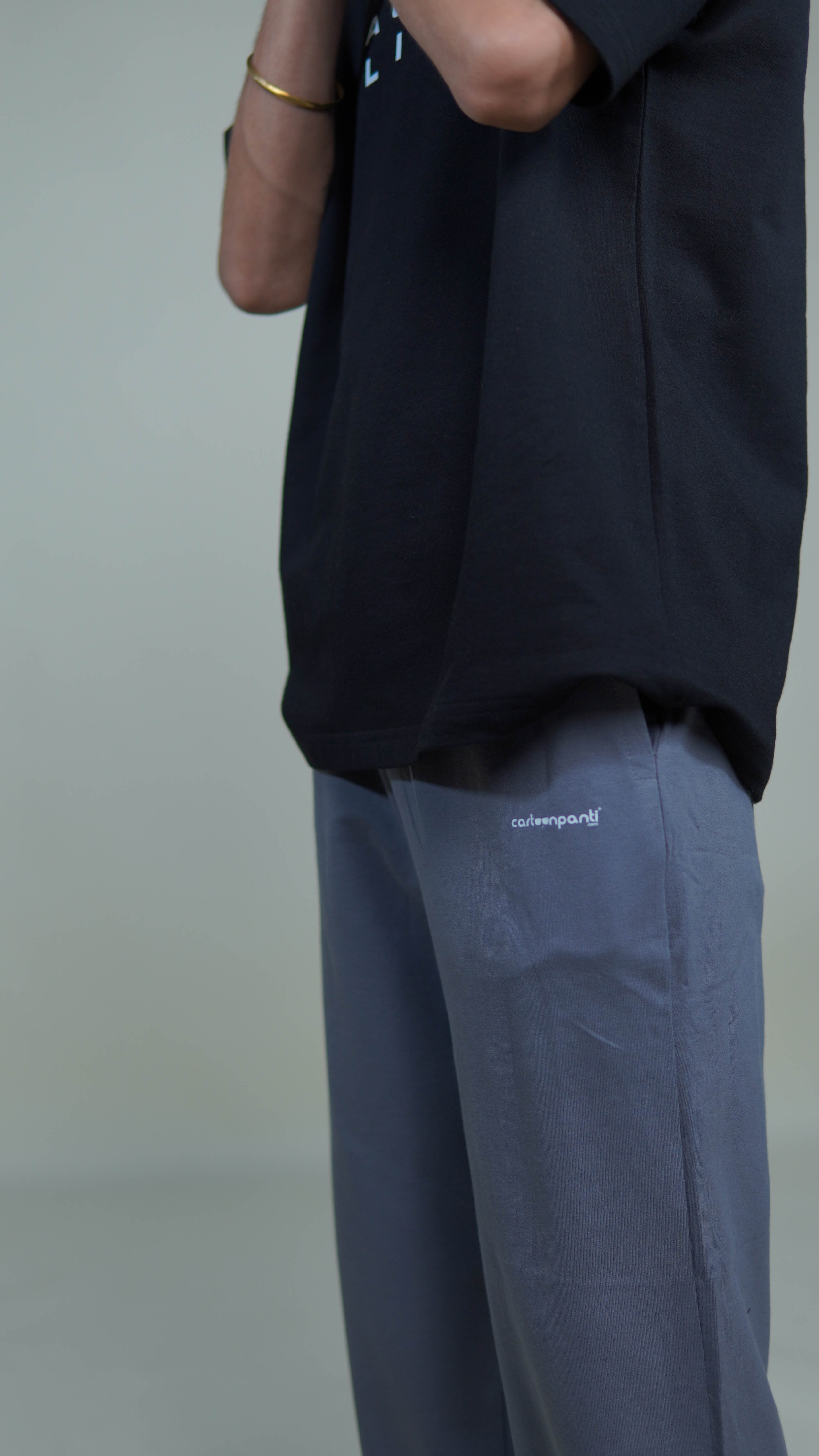 grey joggers with a visible brand logo cartoonpanti on a neutral background