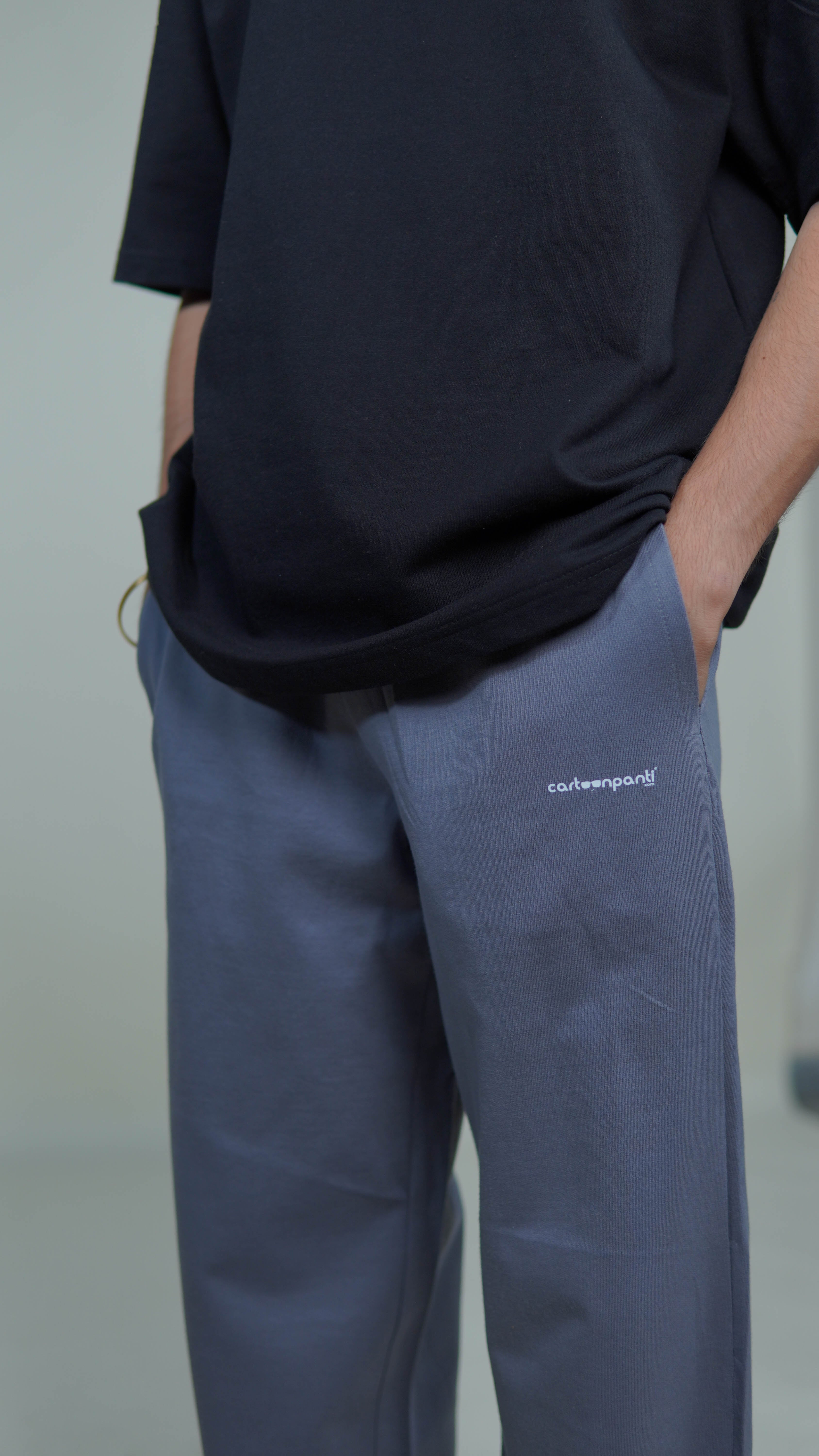 grey joggers with a visible brand logo cartoonpanti on a neutral background