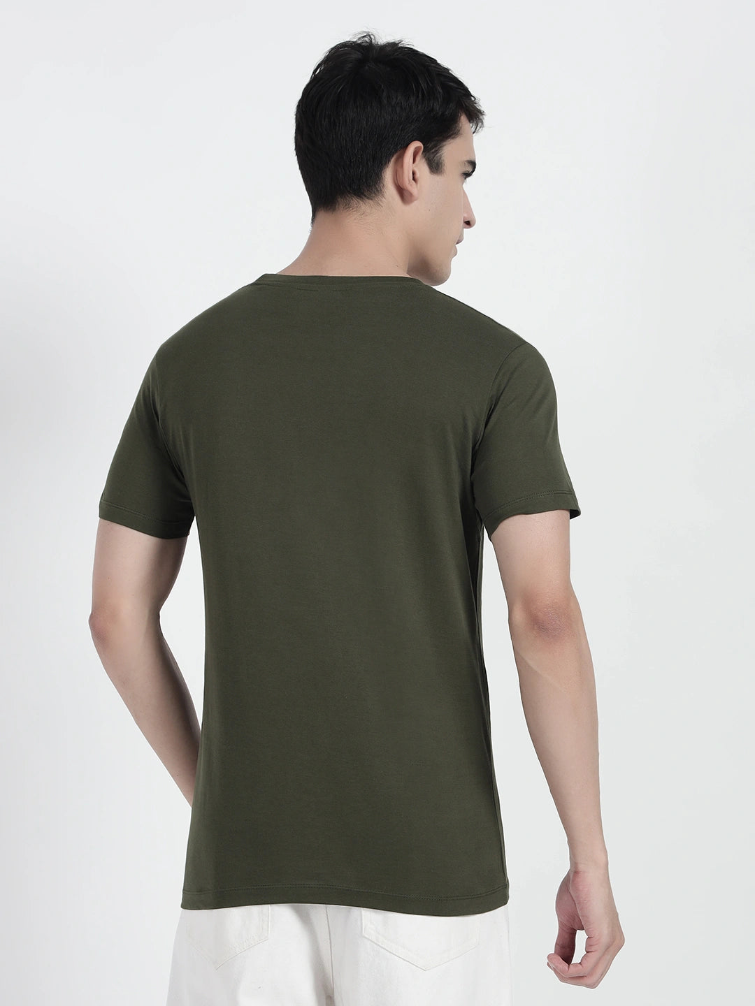 wearing an olive green plain T-shirt by cartoonpanti india 
