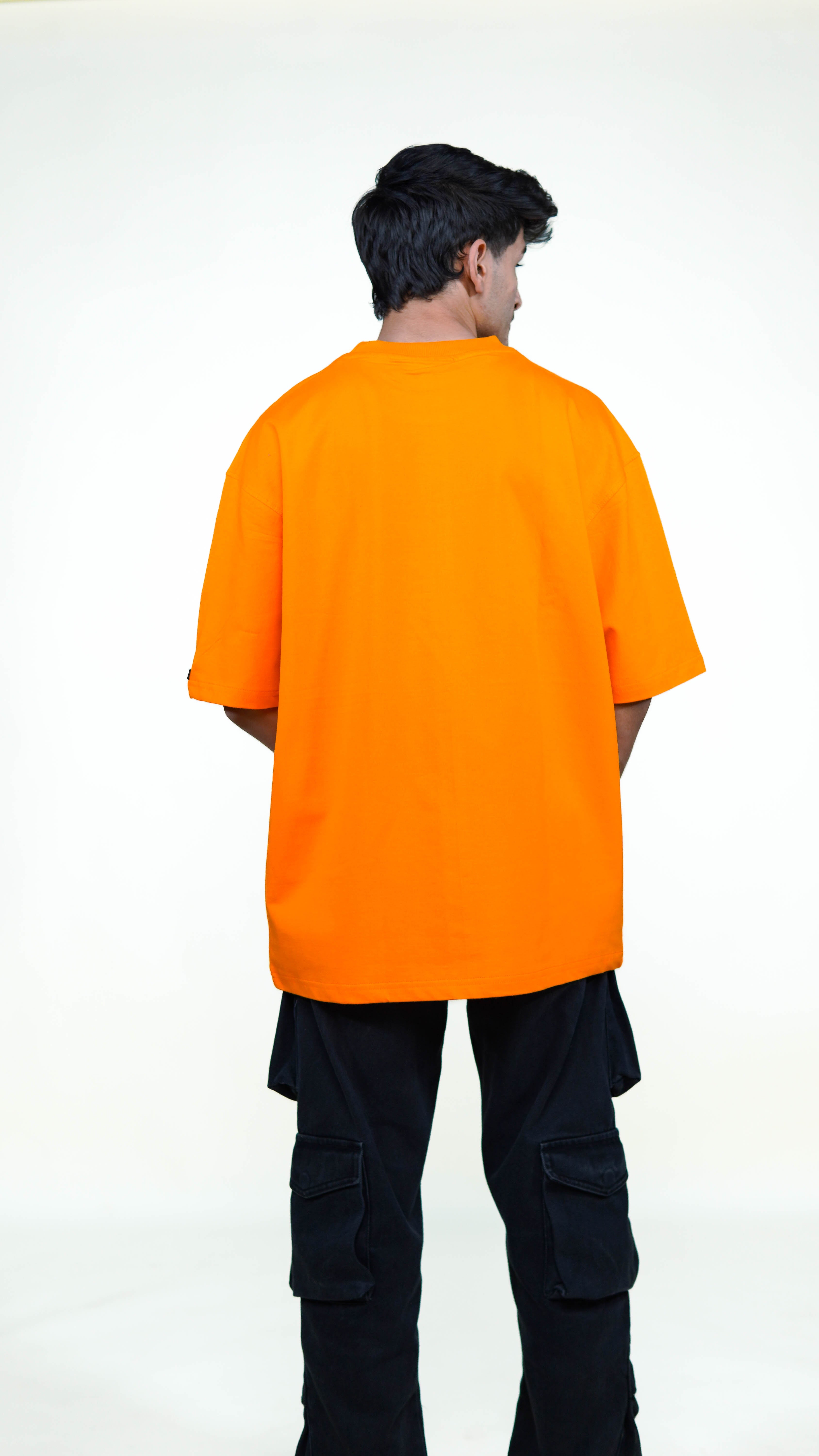 Person wearing an orange t-shirt with a cartoon naruto character