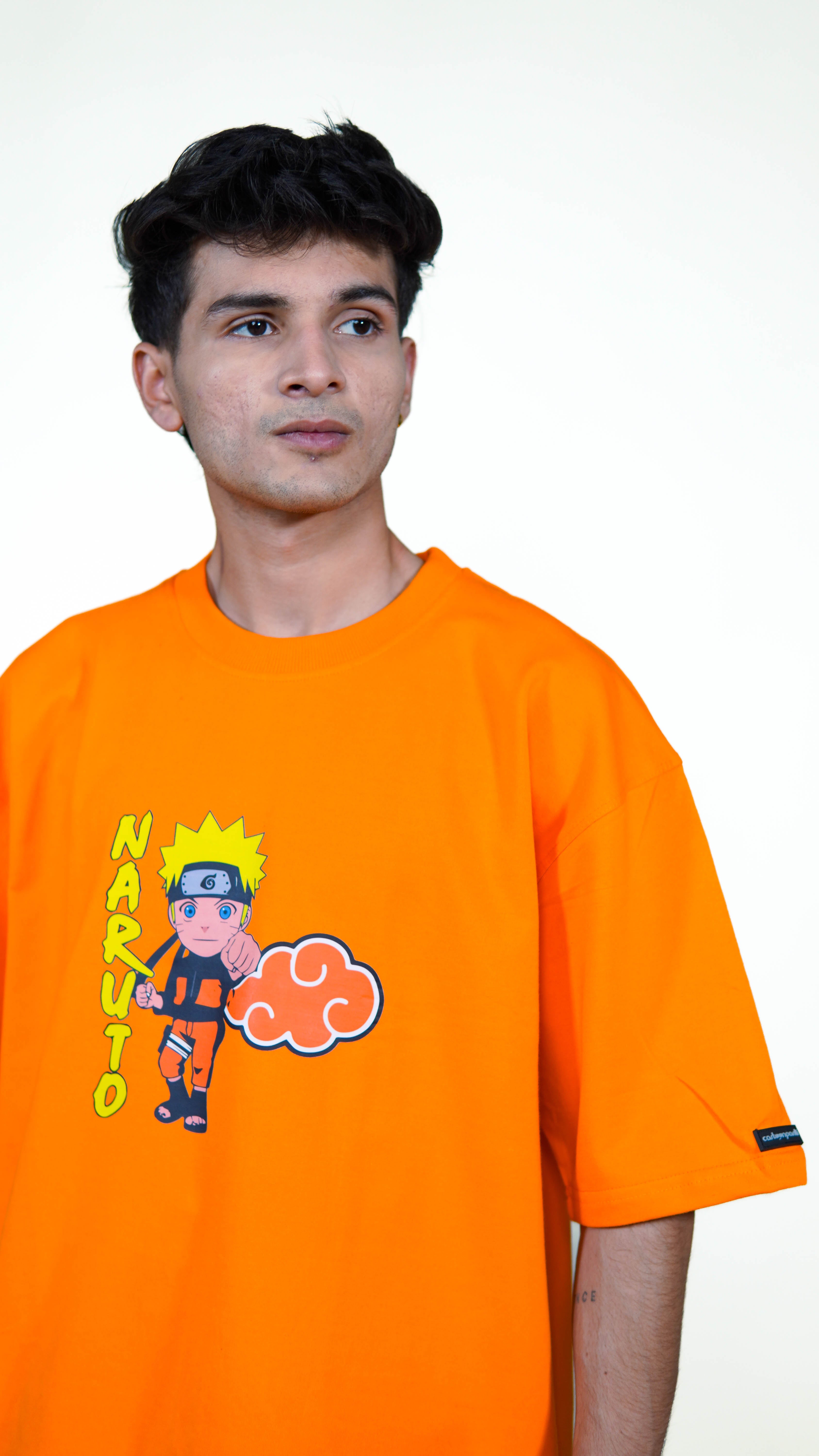 Person wearing an orange t-shirt with a cartoon naruto character