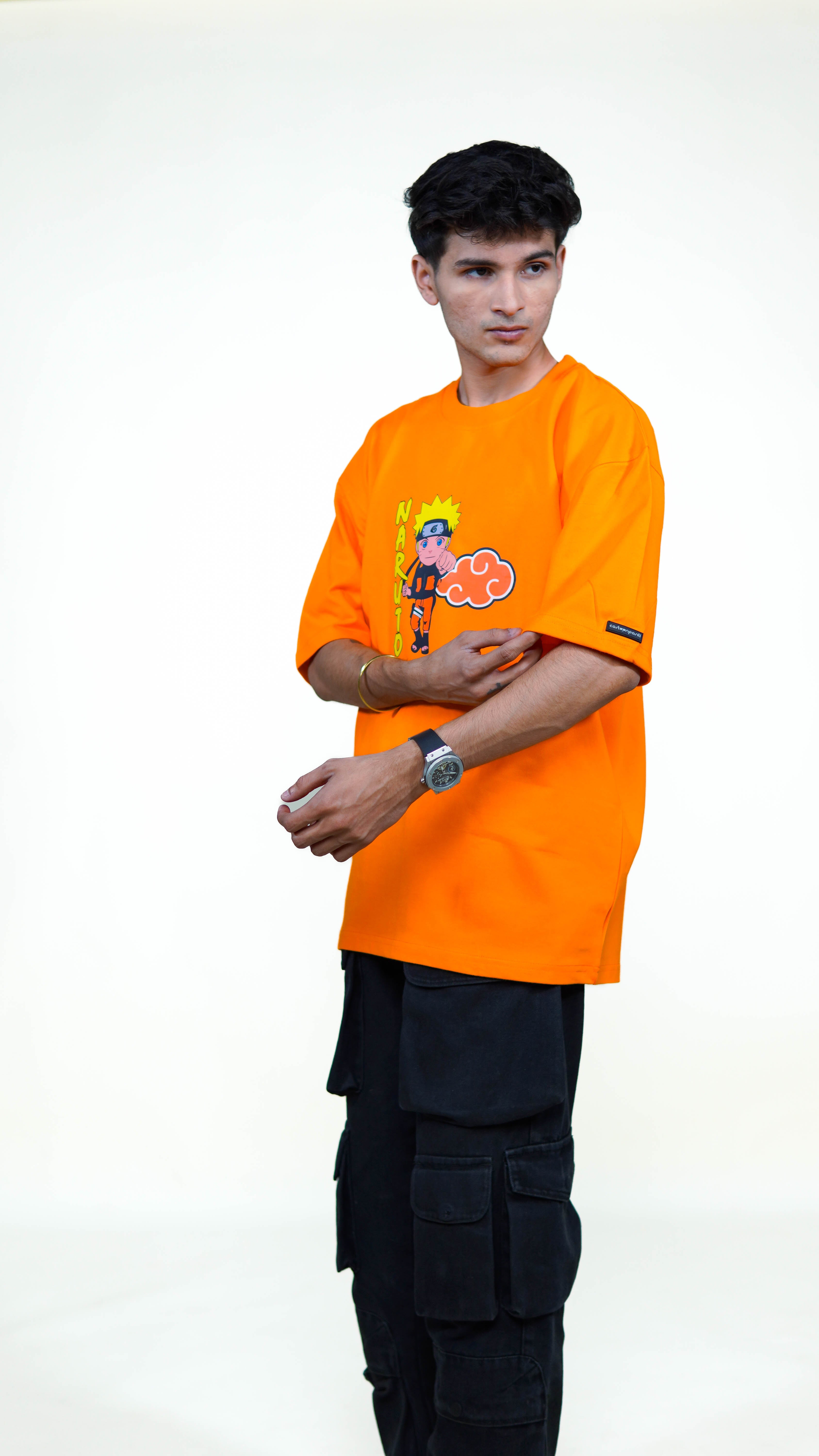 Person wearing an orange t-shirt with a cartoon naruto character