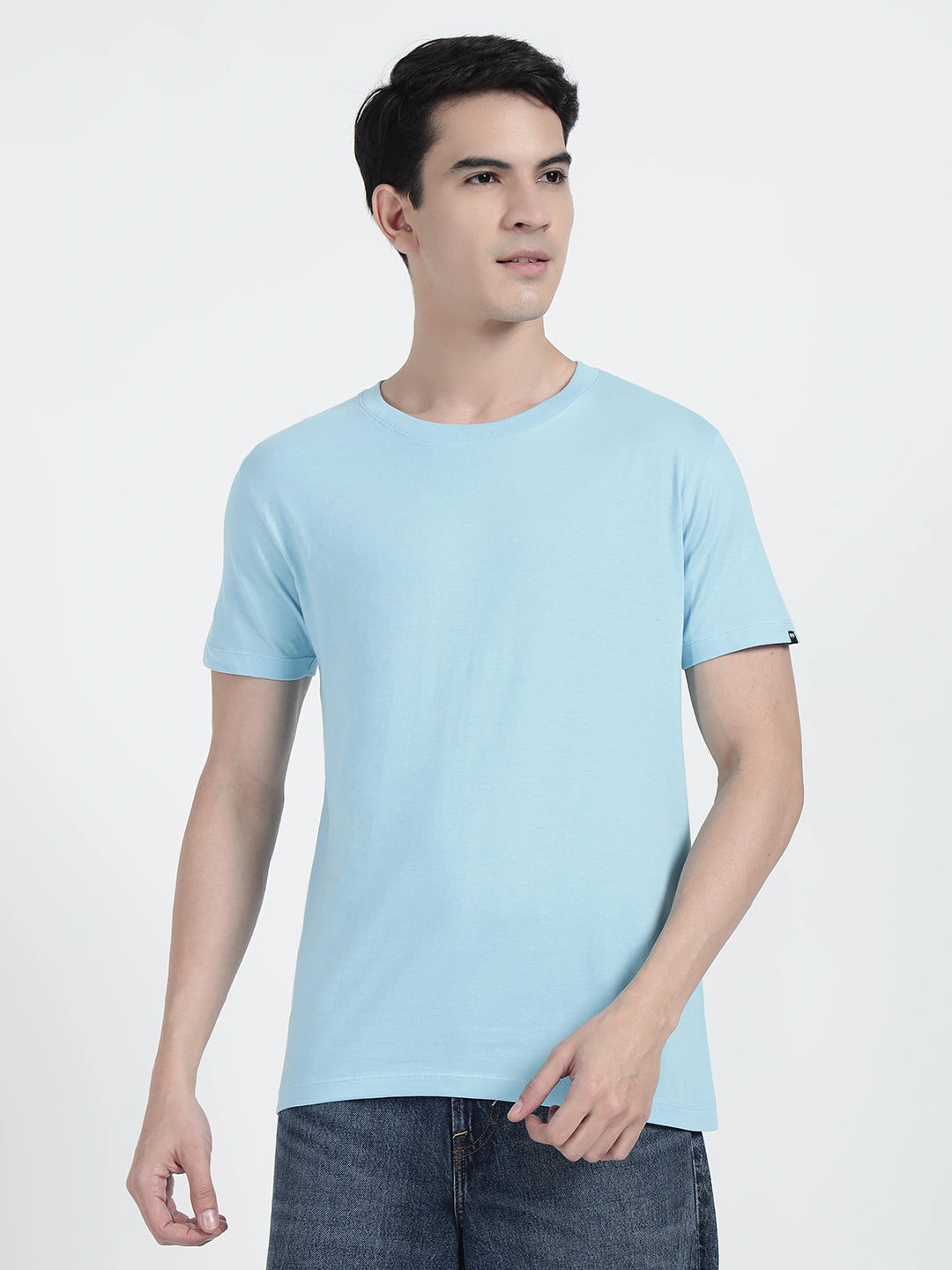 A man wearing a sky blue plain T-shirt by cartoonpnti india