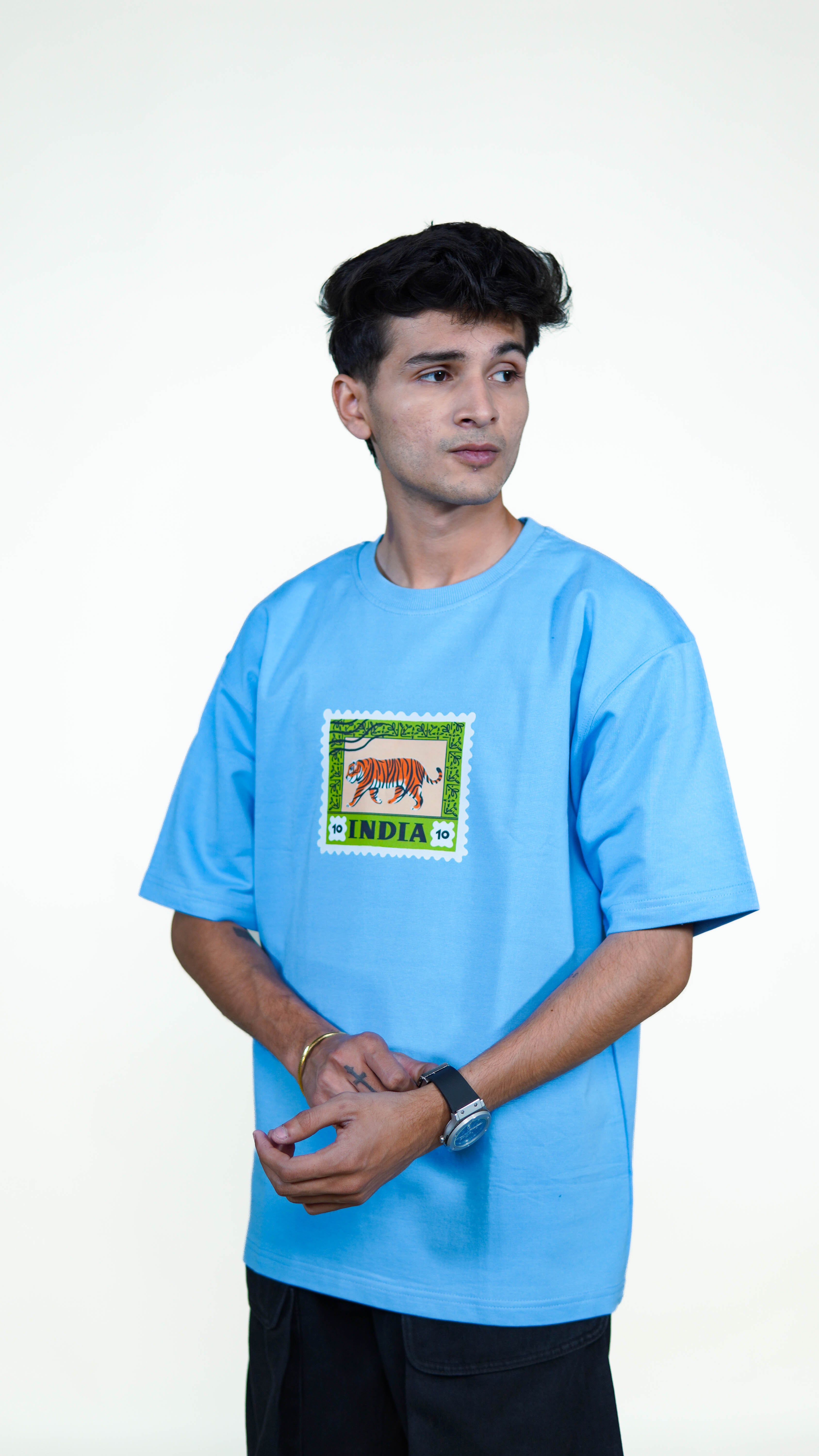 Man wearing a light sky blue t-shirt with a graphic design indian Tiger on a white background