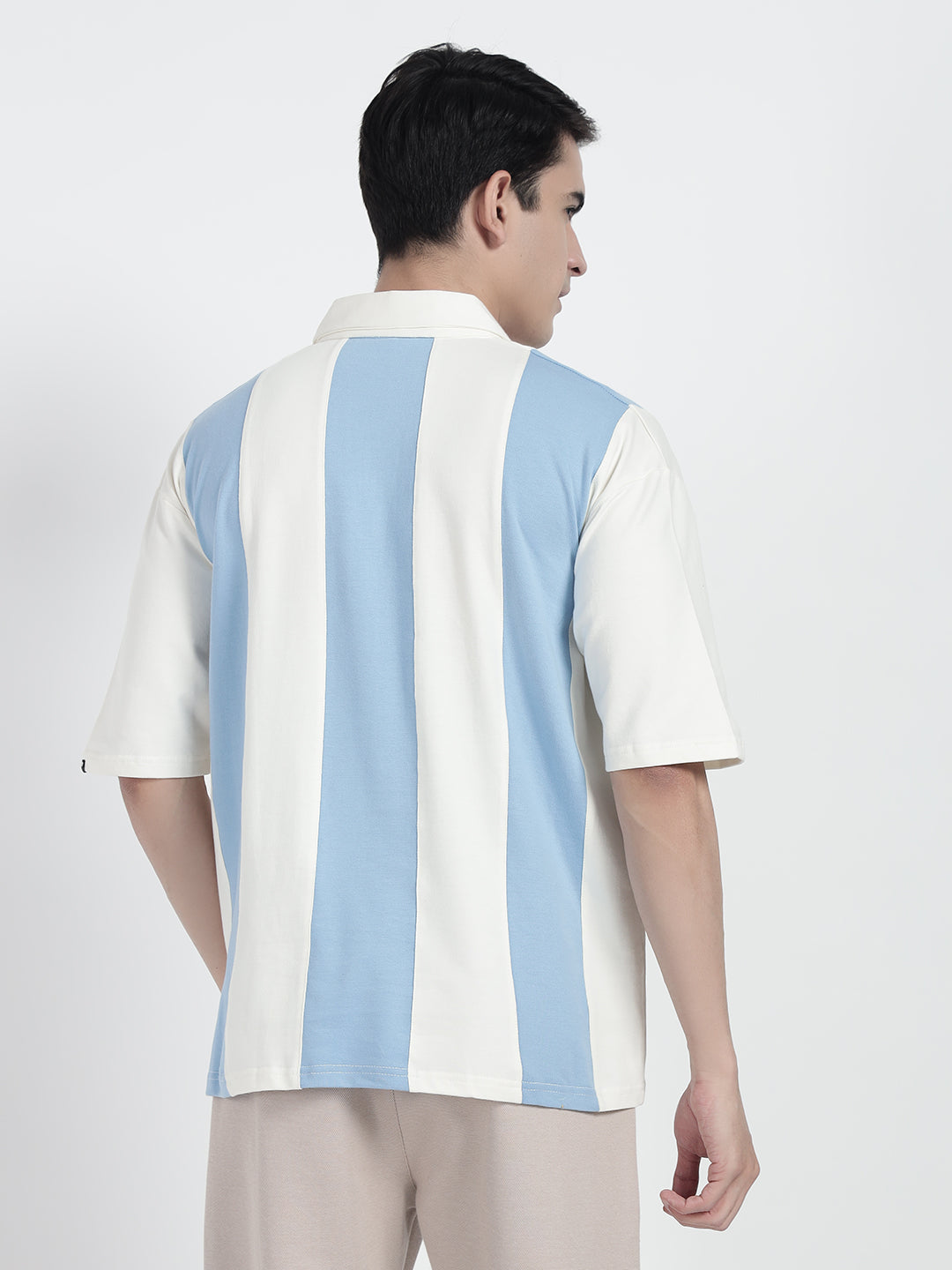 wearing a striped oversized polo shirt in white by cartoonpanti india
