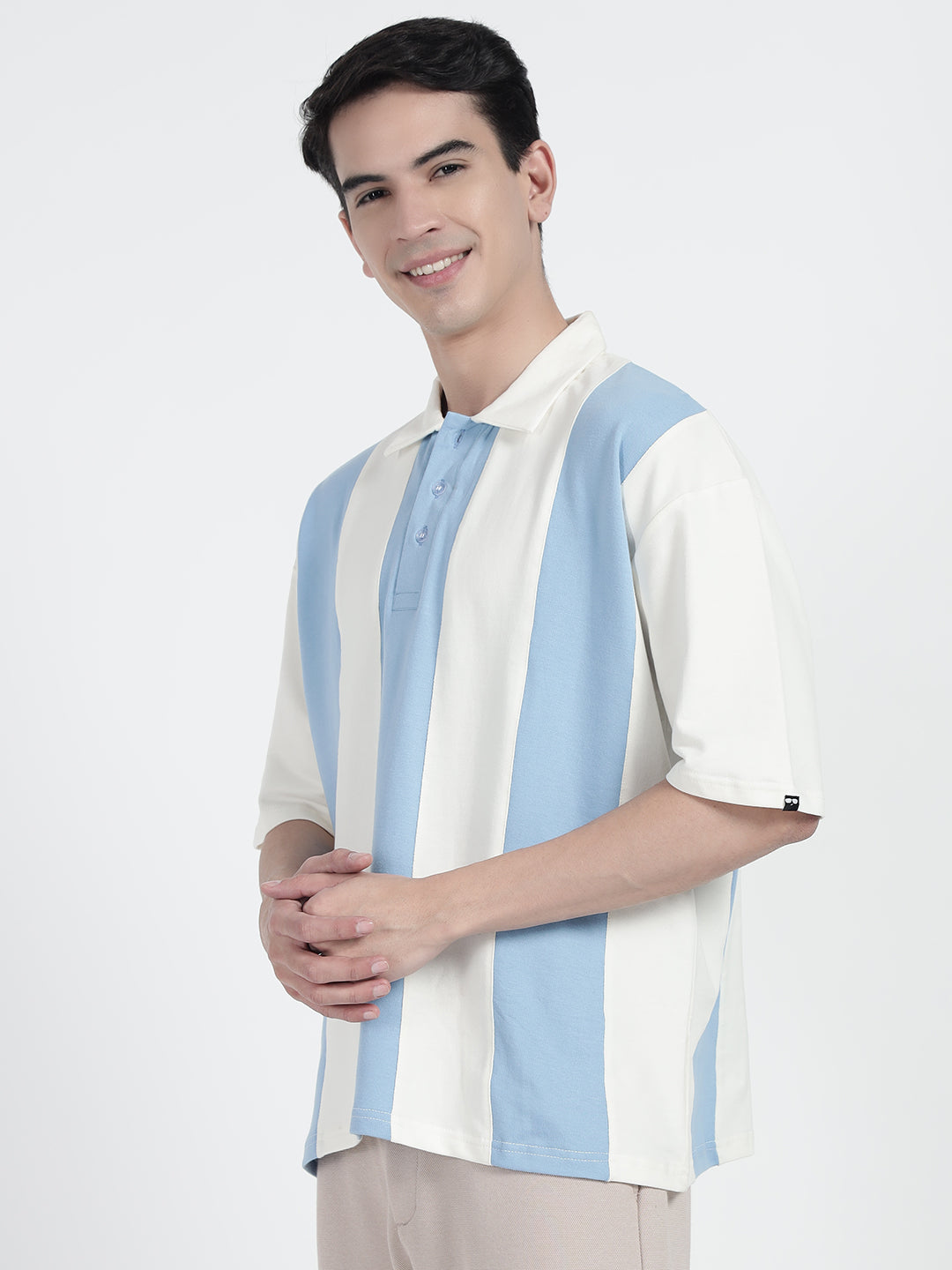 wearing a striped oversized polo shirt in white by cartoonpanti india