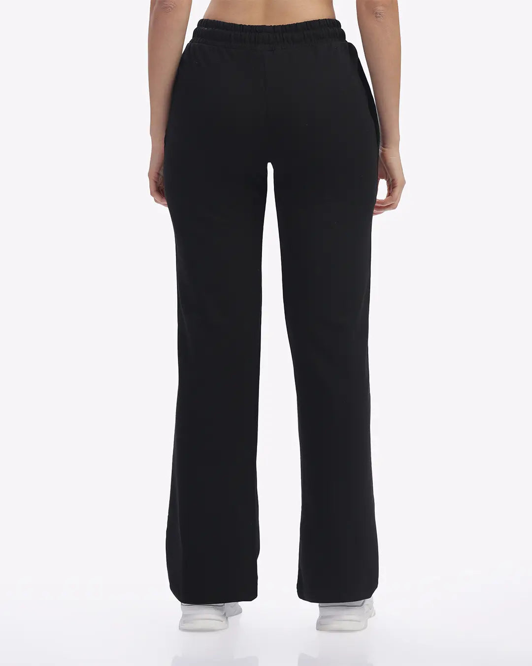 Black joggers worn by a person on a white background