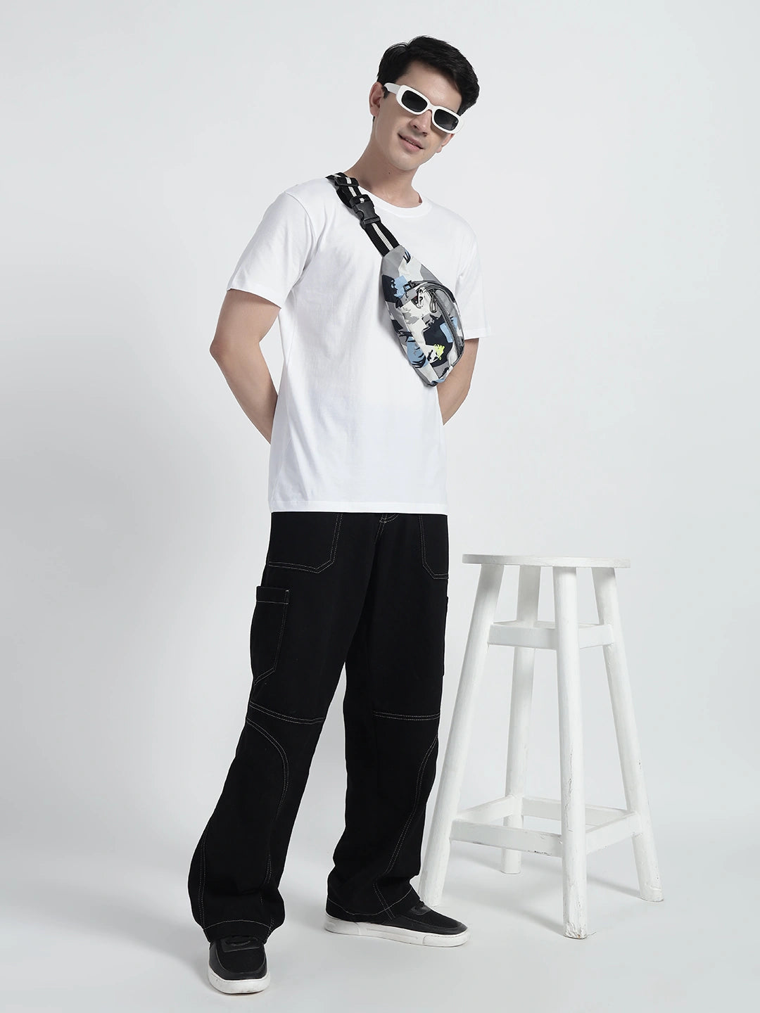 A person wearing a white plain T-shirt by cartoonpanti india.