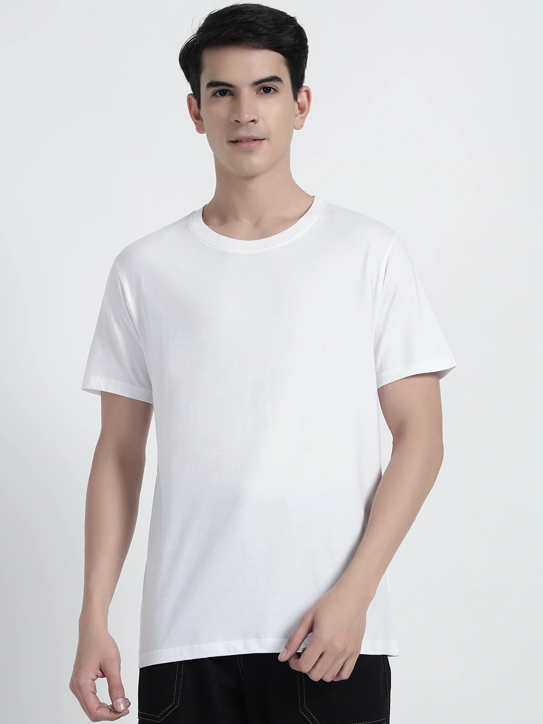 A person wearing a white plain T-shirt by cartoonpanti india.