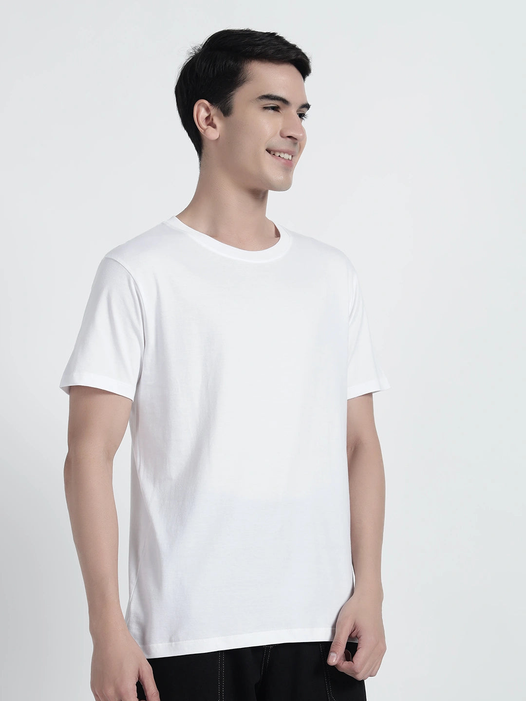 A person wearing a white plain T-shirt by cartoonpanti india.