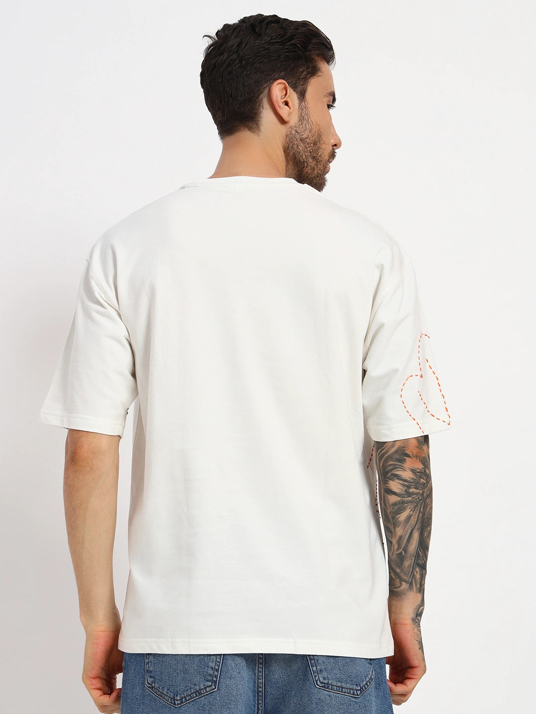 Man wearing a white t-shirt with a subtle design  by cartoonpanti  india