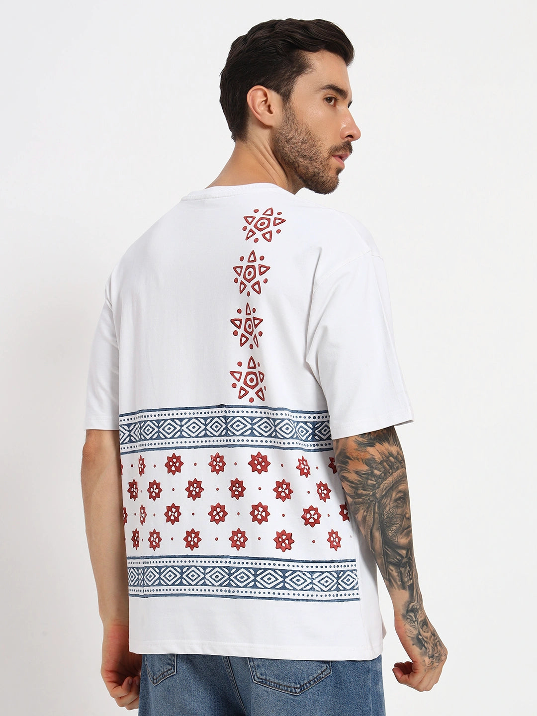 Man wearing a white t-shirt with red and blue patterns on a plain background  by cartoonpanti bindia